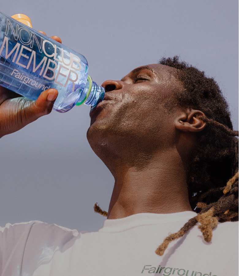 A player drinking from a Fairgrounds "Nonclub Member" water bottle