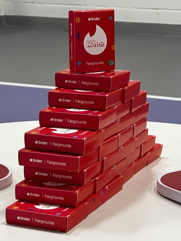 Branded partner kits stacked at an activation