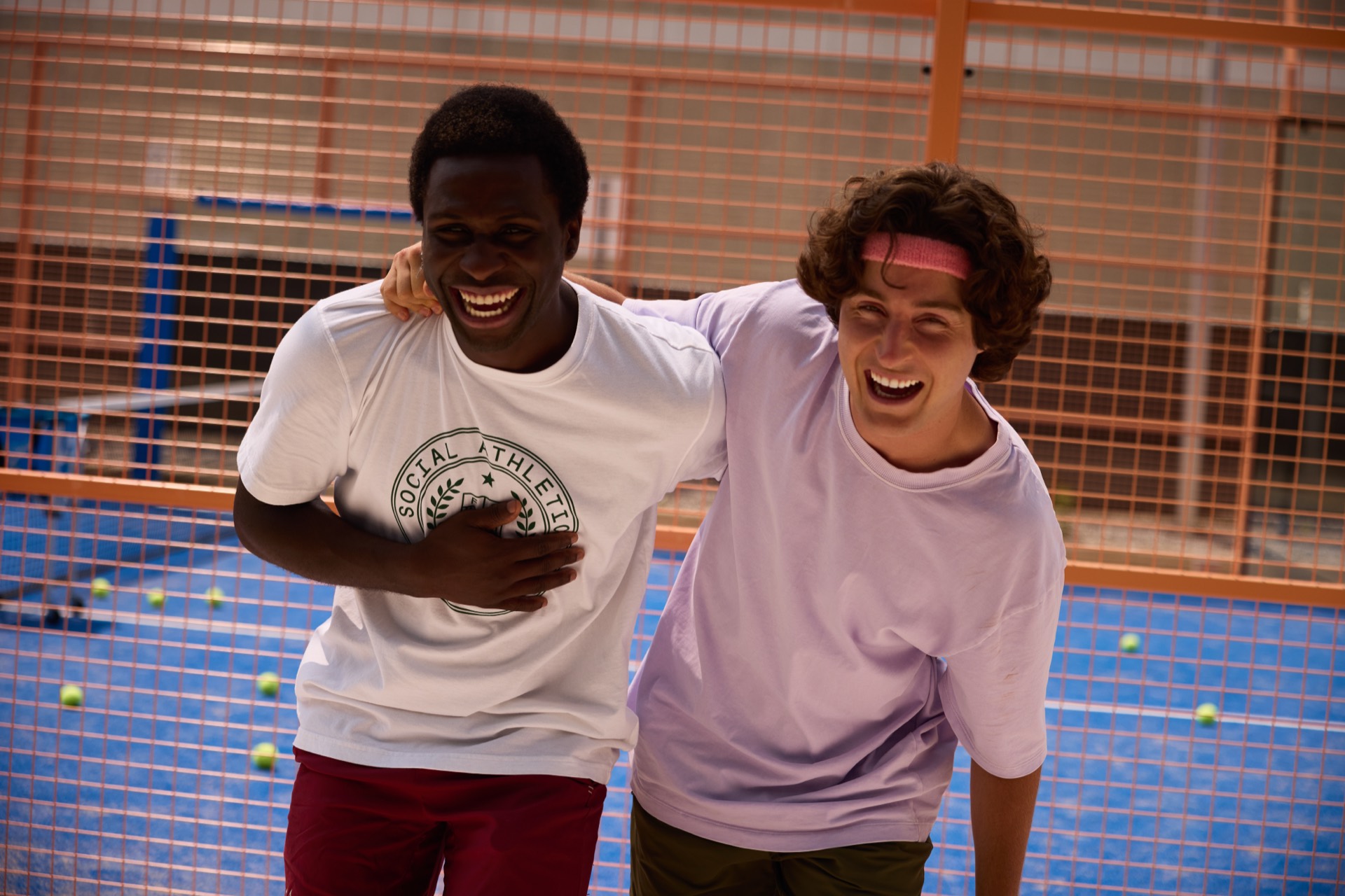 Two players laughing together courtside